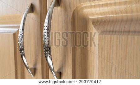 Chrome Handles For Furniture Doors On A Light Background. Interior And Design