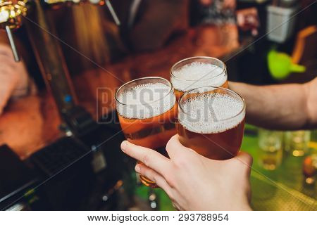 We Meet Oktoberfest. Hand Of Bartender Pouring A Large Lager Beer In Tap. Pouring Beer For Client. S