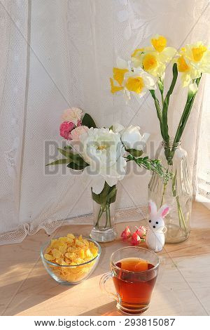 A Mug Of Tea, A Cup Of Corn And A Cake On A Sunny Table, A Bouquet Of Spring Flowers For Mood, Diet 