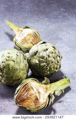 Artichokes On Rustic Background. Fresh Organic Artichoke Flower Set