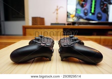 22.03.2019 Eskisehir, Turkey. Two Ps4 Gamepads On Wooden Background Close Up View