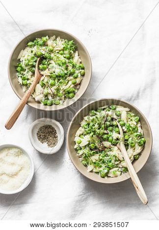 Orzo, Green Peas, Spring Herbs Orzotto On A Light Background, Top View. Vegetarian Food Concept