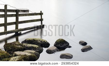Beautiful Landscape Image Of Loughrigg Tarn In Uk Lake District During Moody Evening In Spring