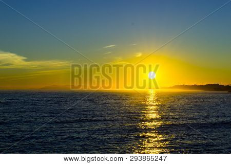 Sunset In Blue And Yellow Light With Sea