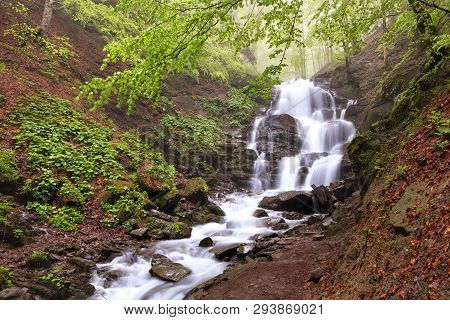 The Rapid Flow Of The Clear Water Of The Shypit Waterfall Makes Its Way Among A Cascade Of Stone Bou
