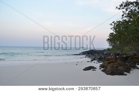 Sunset On The Beach. Scenic Orange Tones Of The Sky, Dark Water, Sand, Relax And Quietness. Imagine 