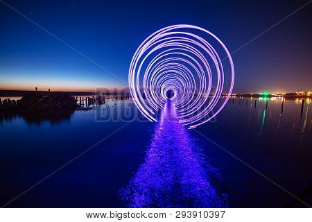 Amazing Laser Fireshow Performance In The Night Blue Sky With Reflections In The Sea Water