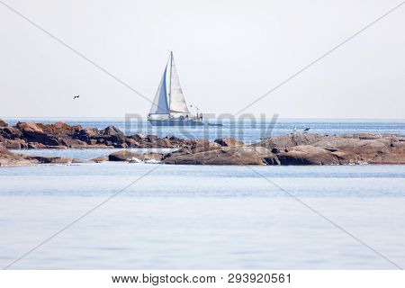 Sailship On The Blue Ocean In The Swedish Archipelago, Islets In The Foreground