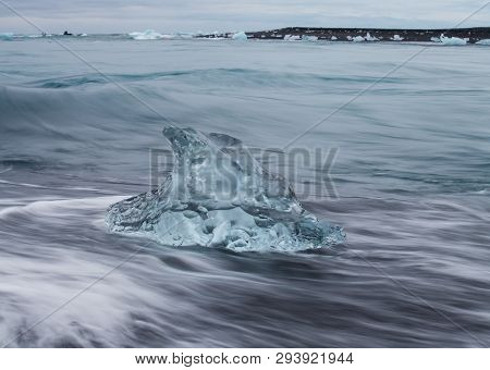 Amazing Transparent Blue Iceberg Pieces On Diamond Beach With Black Sand Near Jokulsarlon Lagoon, Ic