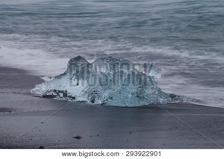 Amazing Transparent Blue Iceberg Pieces On Diamond Beach With Black Sand Near Jokulsarlon Lagoon, Ic