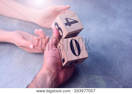 Hand Holding Wooden Cubes With Numbers. Checking The Numbers For Planning. Business Calculating And 
