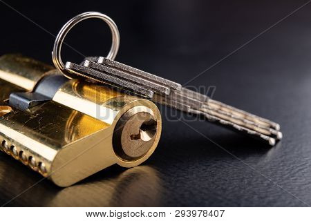 A New Door Lock On A Dark Background. A Patent And Keys To Secure The Front Door.