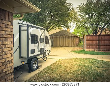 Rv Trailer Parked At Backyard Of Single Family House, Side View