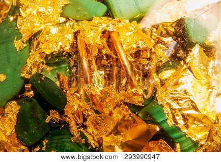 Detailed Close-up Photo Of An Orgone Made Of Green Malachite, Copper, Brass, And Gold.