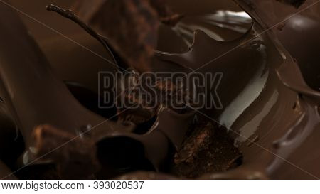 Pouring of delicious dark chocolate, cllose-up.