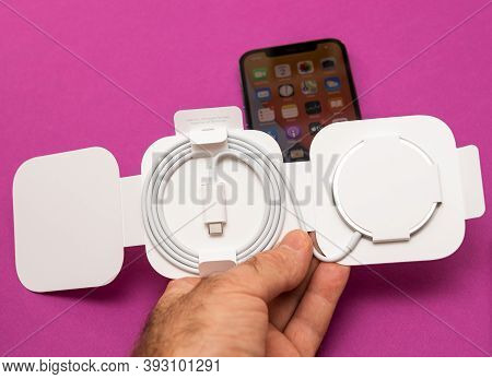Paris, France - Nov 2, 2020: Man Hand Holding New Magsafe By Apple Computers A Proprietary Magnetica