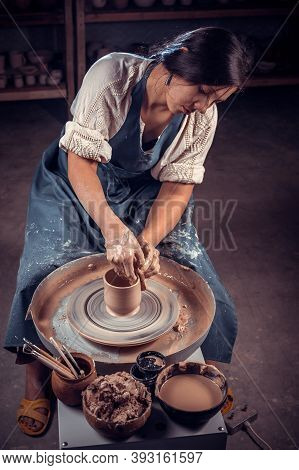 Beautiful Professional Potter Is Working On Pottery Wheel. Hand Work.