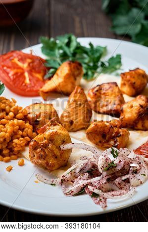 Light And Delicious Grilled Chicken Kebab, Located On A Platter With Tomato And Bulgur, Decorated Wi