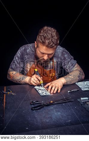 Professional Tanner Creating Leatherwork In His Workshop