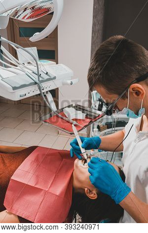 The Dentist Uses A Scaler To Remove Tartar, Oral Hygiene.