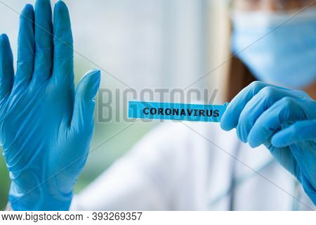 Octor Holding A Paper Card With Text Covid-19
