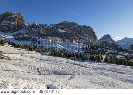 The Valley Of The Gardena Pass With Snow And Blue Sky.
