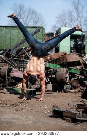 Male Gymnast Standing On Hands And Keeping Balance