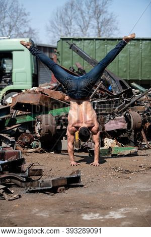 Bodyweight Training Man Standing On Hands In Junkyard