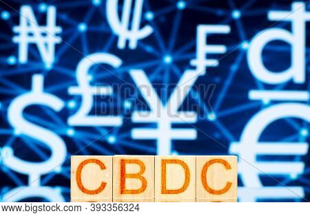 Cbdc. Wooden Cubes With The Inscription Cbdc On The Background Of Symbols Of National Cryptocurrenci