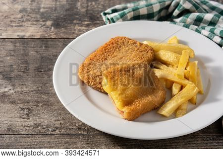 San Jacobo Steak Filled With Cheese And Ham On Wooden Table