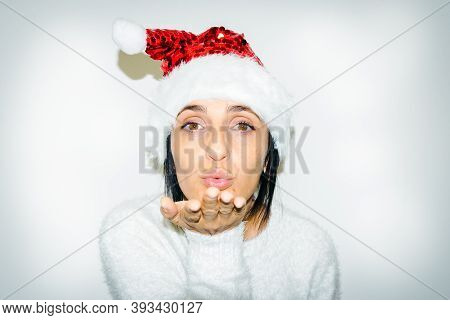 Close Up Face Of Lovely Young Caucasian Woman With Red Hat Looking Straight And Sending Imaginery Ki