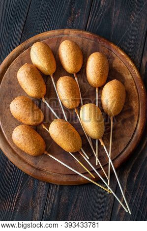 Corn Dogs On Wooden Board