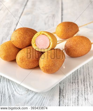 Corn Dogs On White Serving Plate