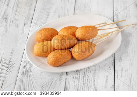 Corn Dogs On White Serving Plate