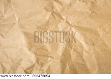 Crumpled Brown Paper Textured Background. Craft Paper.