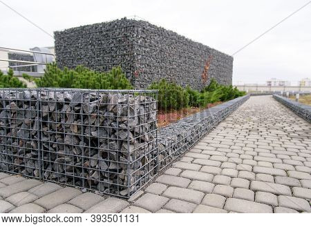 Gabion Stone Fence. Elements Of Angular Rock And Wire Mesh Gabions.