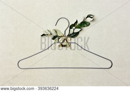 Iron Hanger With Sprig Of The Tree With Leaves On Linen Background. Natural Aestetic, Eco-friendly, 