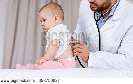 Medical Checkup. Doctor Examining Baby Girl Listening To Her Lungs Using Stethoscope In Hospital. Il