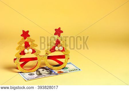 New Years, Christmas Masquerade Glasses And Money, Dollars - Lie On A Yellow Background. A Hostile B