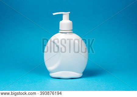 White Bottle, Dispenser For Liquid Soap, Antiseptic On A Blue Background. Mockup, Place For Text.