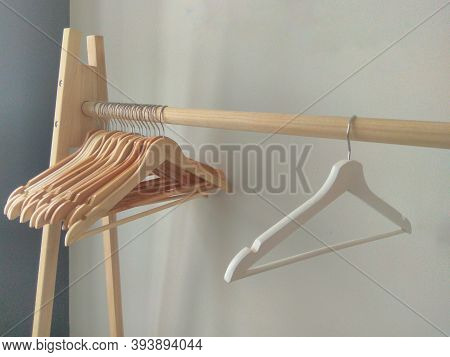 Many Empty Wooden Clothes Hangers On The Rack Store Concept, Sale, Design, Empty Hangers.