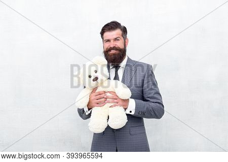 Huggably Soft And Ideal For Cuddling. Happy Businessman Hold Teddy Bear Toy Blue Background. Bearded