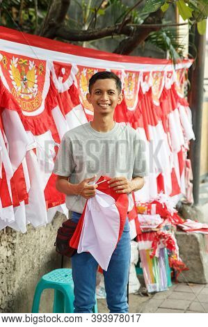 Portrait Of A Young Man Selling Flags