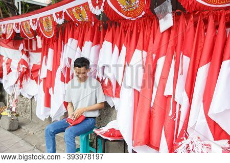 Portrait Of A Young Man Folding Flags
