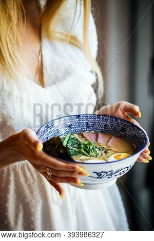 Woman In White Dress Holding Asian Japanese Shio Ramen Noodle Soup