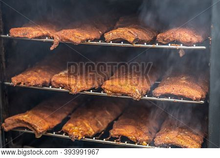 Smoke Rising Around A Slow Cooked Beef Brisket On A Smoker Barbecue Grilling Concept