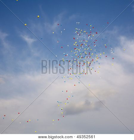Varicoloured balloons fly on air on a background sky