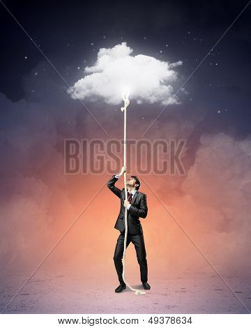 Image of businessman climbing rope