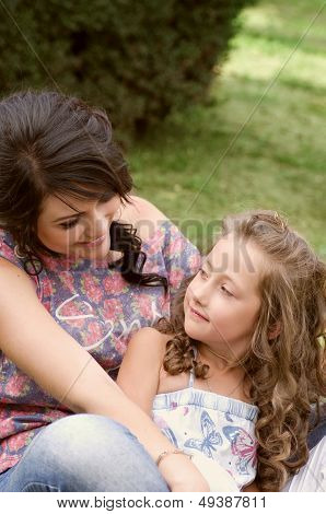 Pretty smiling mother and daughter