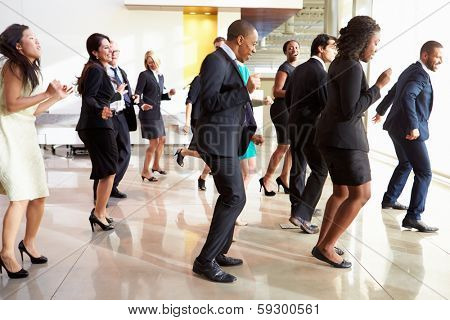 Businessmen And Businesswomen Dancing In Office Lobby